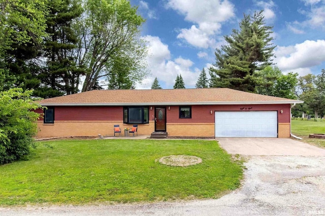 803 Locust St, Princeton, IA 52768 - single story home with brick siding, an attached garage, concrete driveway, and a front lawn