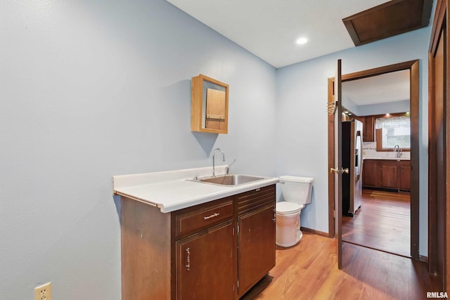803 Locust St, Princeton, IA 52768 - bar featuring a sink, stainless steel fridge with ice dispenser, light wood finished floors, and baseboards
