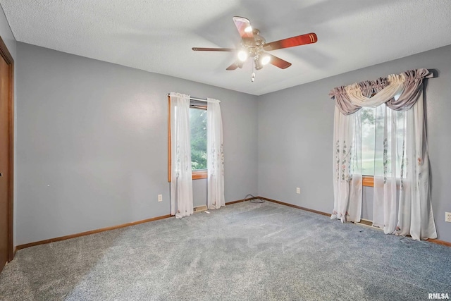 803 Locust St, Princeton, IA 52768 - spare room with a ceiling fan, carpet, baseboards, and a textured ceiling