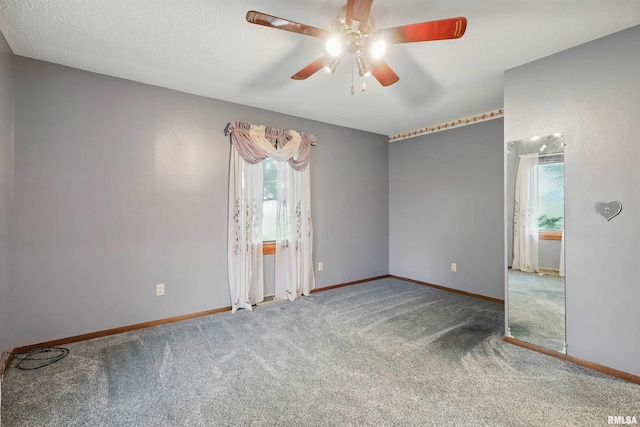 803 Locust St, Princeton, IA 52768 - empty room with plenty of natural light, carpet, ceiling fan, and baseboards