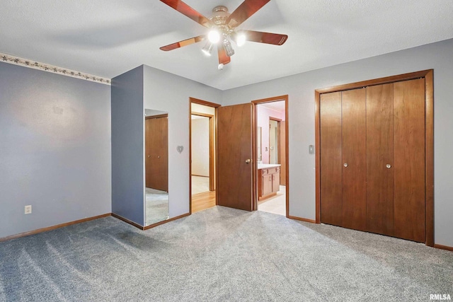 803 Locust St, Princeton, IA 52768 - unfurnished bedroom with light colored carpet, baseboards, ensuite bath, and ceiling fan