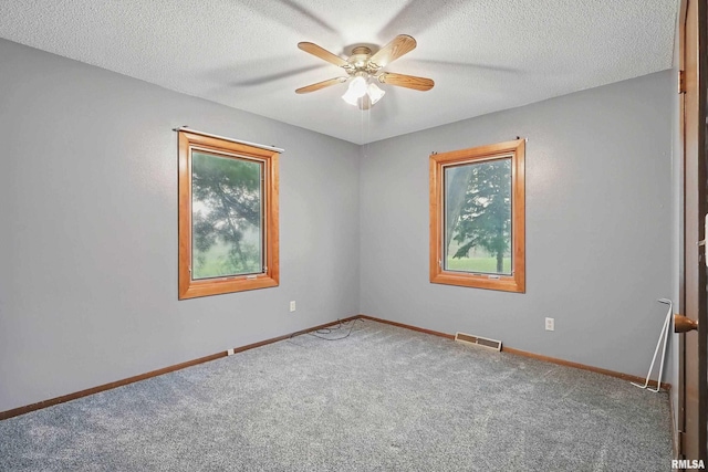 803 Locust St, Princeton, IA 52768 - carpeted spare room featuring ceiling fan, baseboards, and a textured ceiling