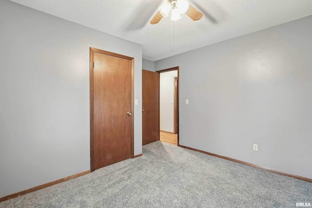 803 Locust St, Princeton, IA 52768 - carpeted spare room featuring a ceiling fan and baseboards