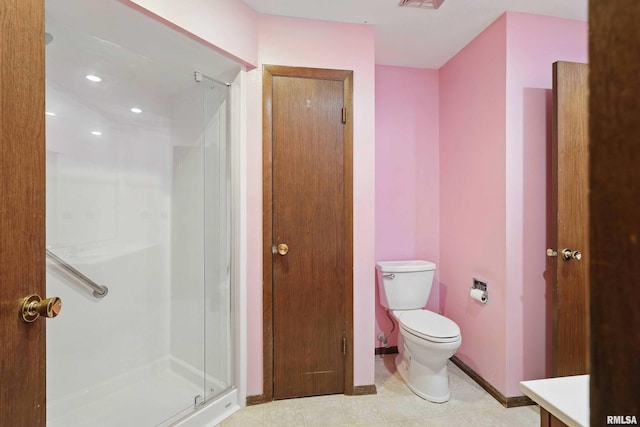803 Locust St, Princeton, IA 52768 - full bathroom featuring a shower stall, toilet, vanity, baseboards, and tile patterned floors