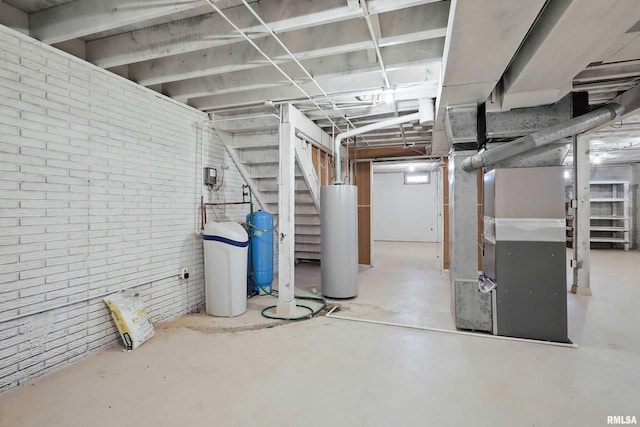 803 Locust St, Princeton, IA 52768 - unfinished basement with water heater, stairway, a water softener, heating unit, and a water pressure tank