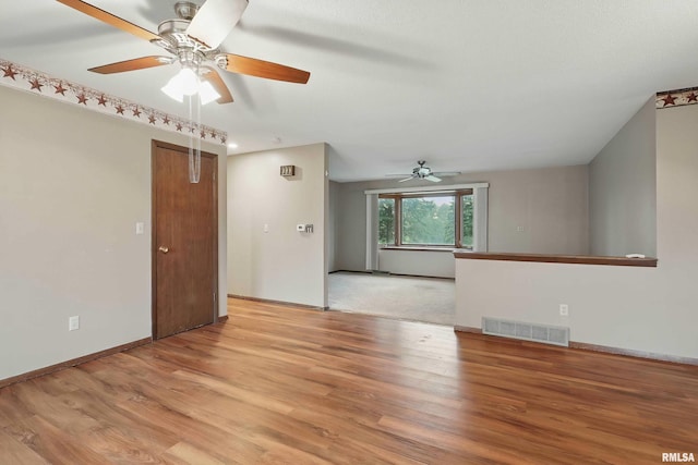 803 Locust St, Princeton, IA 52768 - empty room featuring a ceiling fan, light wood-style floors, and baseboards