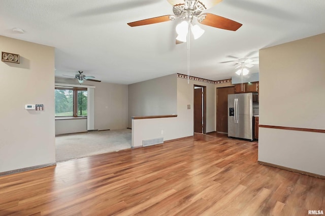 803 Locust St, Princeton, IA 52768 - unfurnished living room with light wood-style flooring, ceiling fan, and baseboards