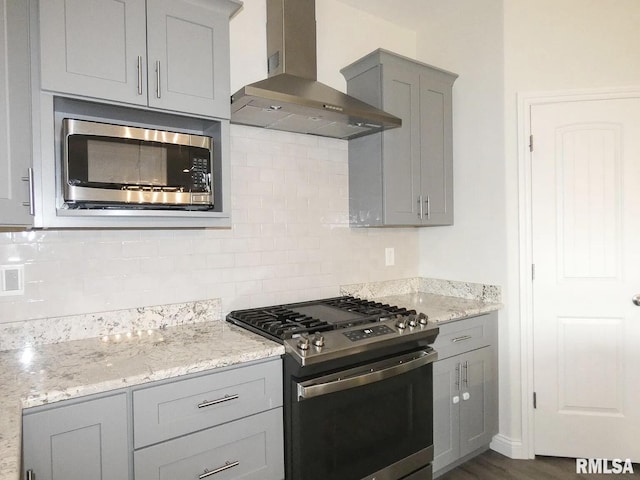 11401 N Joseph St, Dunlap, IL 61525 - kitchen featuring wall chimney exhaust hood, appliances with stainless steel finishes, gray cabinets, decorative backsplash, and light stone countertops