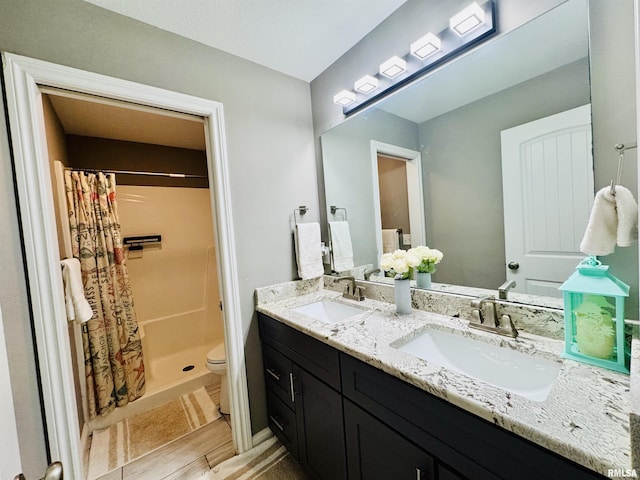 11401 N Joseph St, Dunlap, IL 61525 - bathroom featuring double vanity, a shower stall, and wood finished floors
