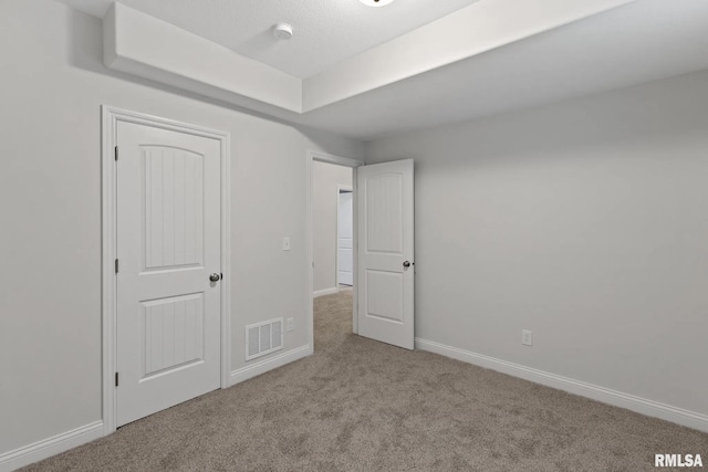 11401 N Joseph St, Dunlap, IL 61525 - unfurnished bedroom featuring carpet floors and a tray ceiling