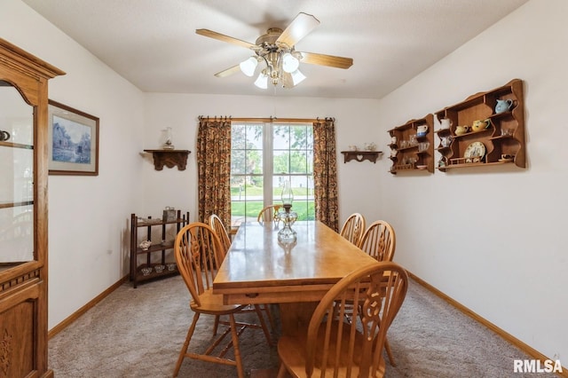 1530 N Pine St, Davenport, IA 52804 - dining area featuring light colored carpet, a ceiling fan, and baseboards