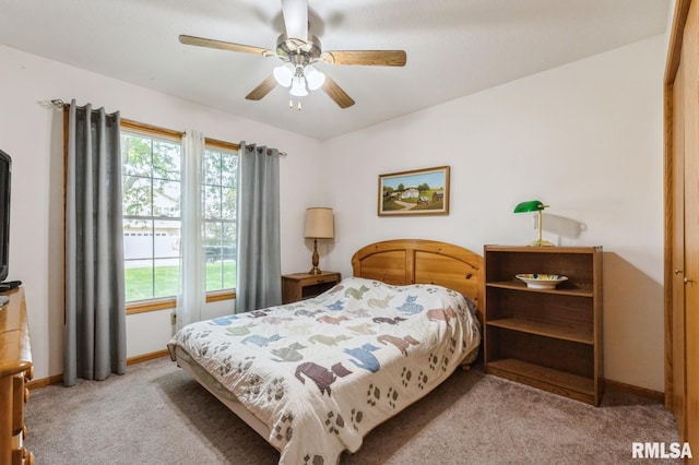 1530 N Pine St, Davenport, IA 52804 - bedroom with light carpet, baseboards, and ceiling fan