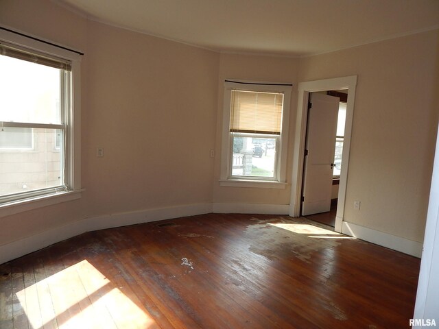 1115 W Locust St, Davenport, IA 52804 - spare room with hardwood / wood-style flooring, baseboards, and crown molding