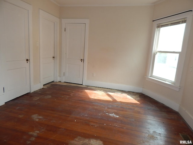 1115 W Locust St, Davenport, IA 52804 - unfurnished bedroom with wood-type flooring, ornamental molding, and baseboards