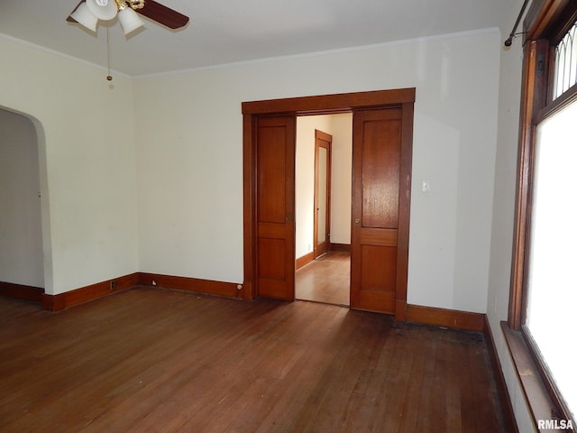 1115 W Locust St, Davenport, IA 52804 - spare room with wood-type flooring, ceiling fan, arched walkways, plenty of natural light, and ornamental molding