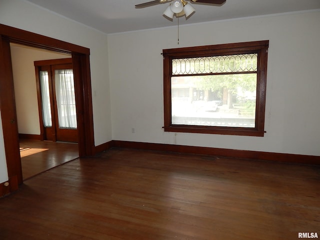 1115 W Locust St, Davenport, IA 52804 - unfurnished room featuring healthy amount of natural light, a ceiling fan, crown molding, wood finished floors, and baseboards