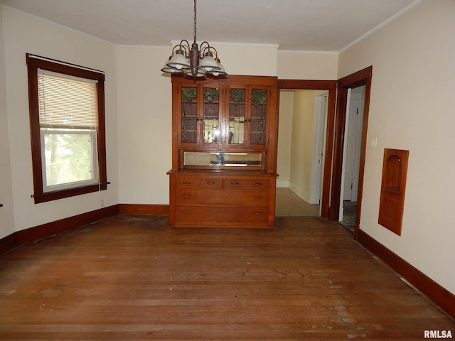 1115 W Locust St, Davenport, IA 52804 - dining space featuring a chandelier, wood finished floors, crown molding, and baseboards