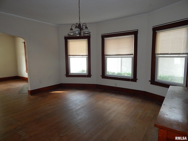 1115 W Locust St, Davenport, IA 52804 - unfurnished room featuring healthy amount of natural light, dark wood-style floors, a chandelier, and baseboards