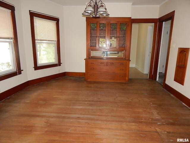 1115 W Locust St, Davenport, IA 52804 - dining space with a chandelier, light wood-type flooring, and baseboards
