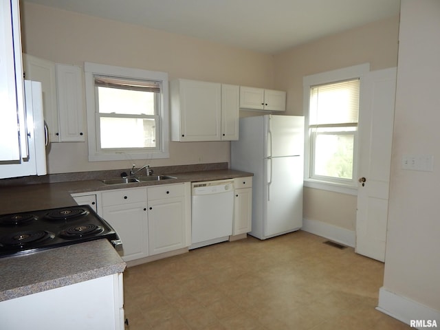 1115 W Locust St, Davenport, IA 52804 - kitchen with white appliances, a sink, white cabinetry, and baseboards