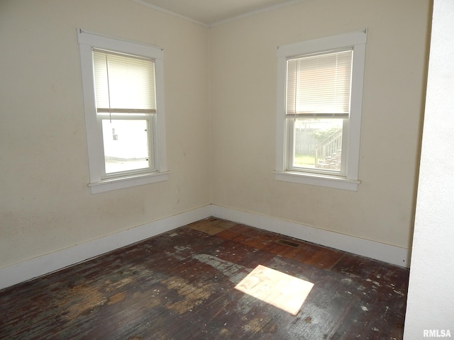 1115 W Locust St, Davenport, IA 52804 - spare room featuring plenty of natural light, hardwood / wood-style flooring, baseboards, and crown molding