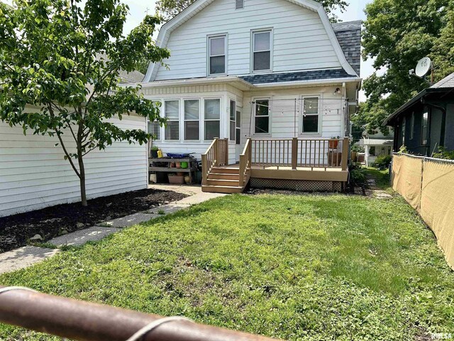 2723 Iowa St, Davenport, IA 52803 - colonial inspired home featuring a shingled roof, a gambrel roof, and a deck