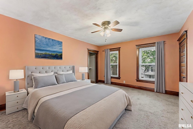 2723 Iowa St, Davenport, IA 52803 - bedroom with baseboards, light colored carpet, and ceiling fan