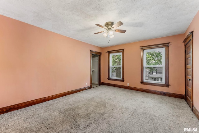 2723 Iowa St, Davenport, IA 52803 - spare room with baseboards, carpet, a ceiling fan, and a textured ceiling