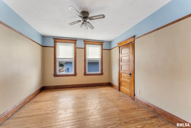 2723 Iowa St, Davenport, IA 52803 - unfurnished bedroom featuring light wood-type flooring, baseboards, and ceiling fan
