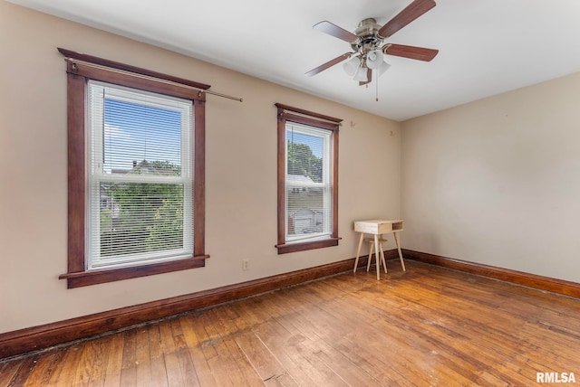 2723 Iowa St, Davenport, IA 52803 - spare room with baseboards, wood-type flooring, and ceiling fan