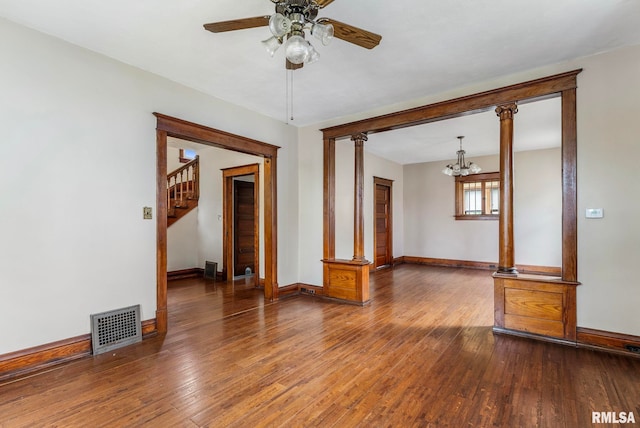 2723 Iowa St, Davenport, IA 52803 - unfurnished room featuring baseboards, a ceiling fan, a chandelier, hardwood / wood-style flooring, and stairs
