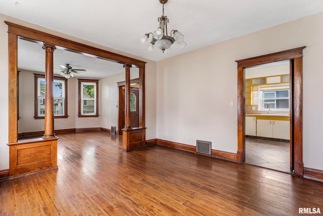 2723 Iowa St, Davenport, IA 52803 - spare room featuring hardwood / wood-style flooring, ornate columns, and baseboards