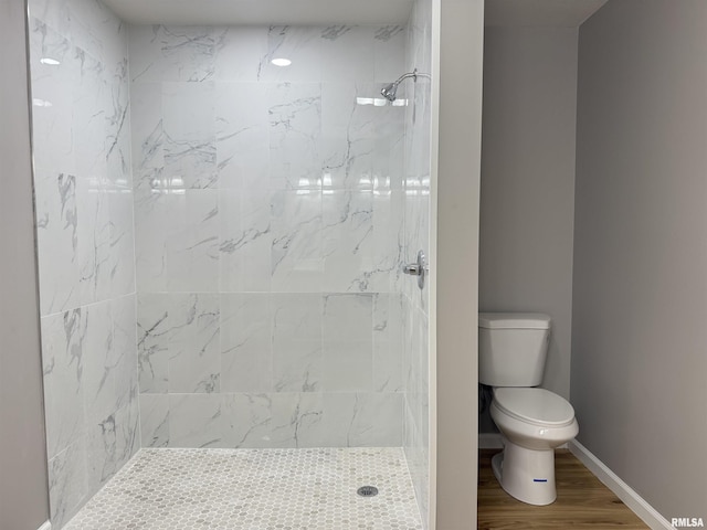 1609 W Chestnut St, Marion, IL 62959 - bathroom with toilet, a tile shower, wood finished floors, and baseboards