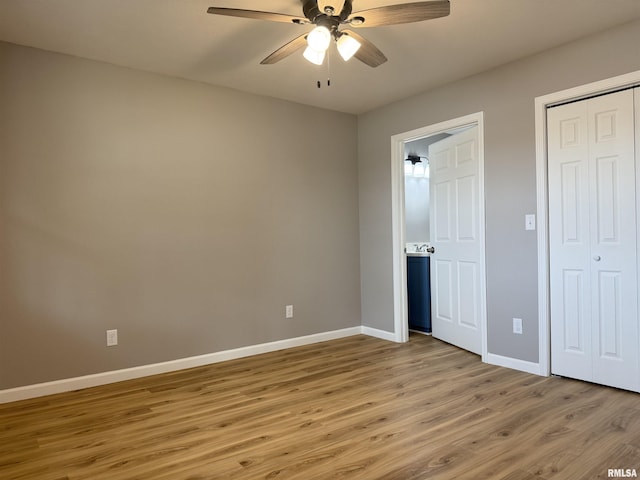 1609 W Chestnut St, Marion, IL 62959 - unfurnished bedroom with baseboards, light wood-style floors, a closet, and ceiling fan