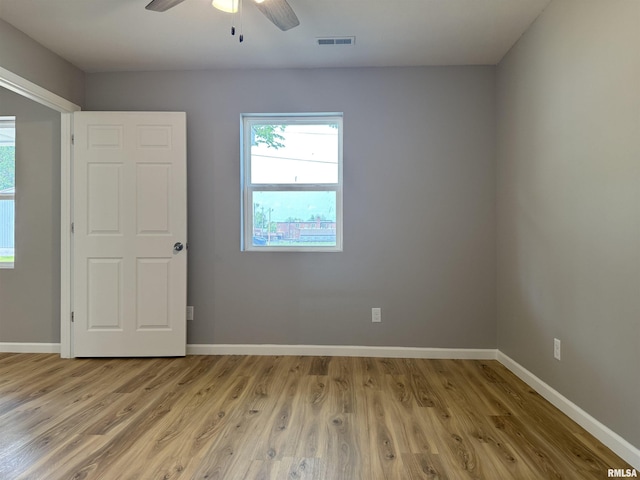 1609 W Chestnut St, Marion, IL 62959 - unfurnished room with light wood finished floors, a ceiling fan, and baseboards