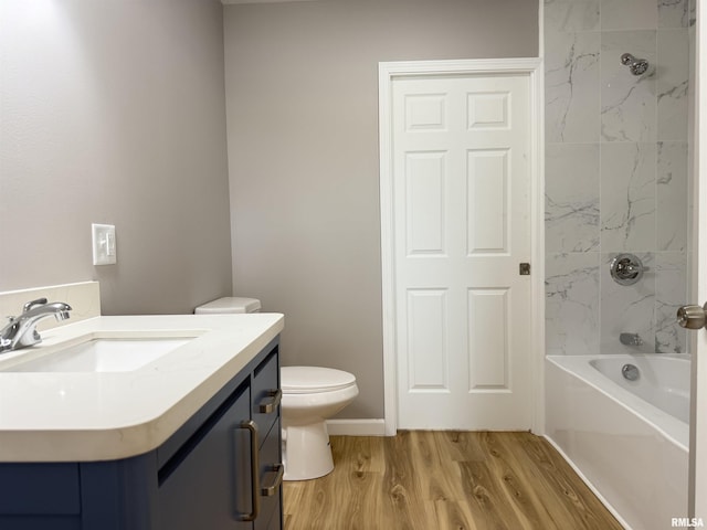 1609 W Chestnut St, Marion, IL 62959 - bathroom with toilet, wood finished floors, vanity, and washtub / shower combination