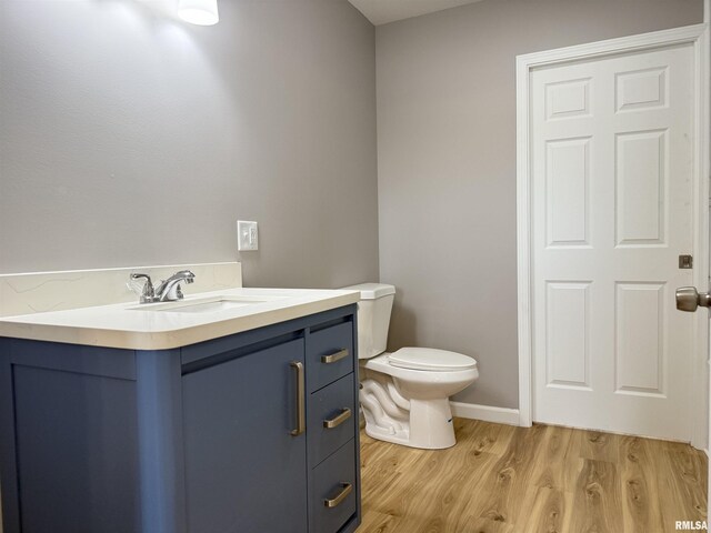 1609 W Chestnut St, Marion, IL 62959 - bathroom featuring vanity, toilet, and wood finished floors