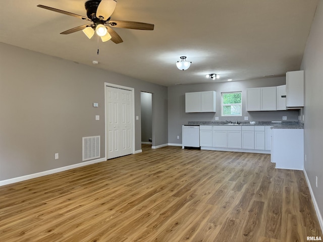 1609 W Chestnut St, Marion, IL 62959 - kitchen featuring dishwasher, light wood-style flooring, baseboards, open floor plan, and white cabinets