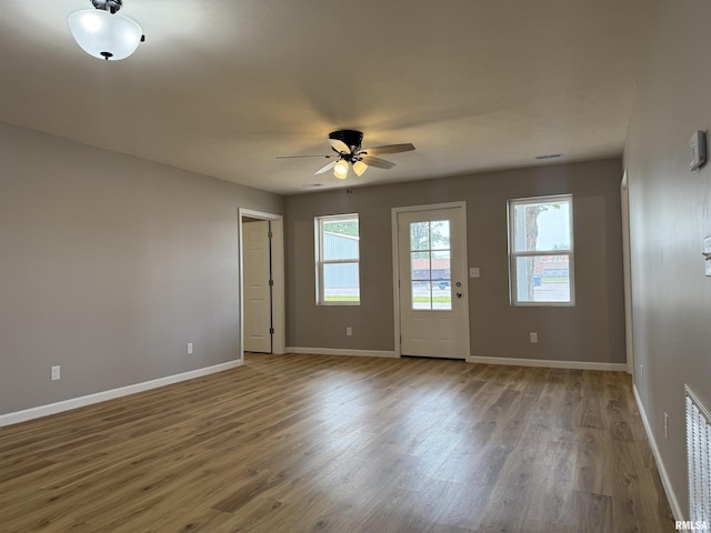 1609 W Chestnut St, Marion, IL 62959 - empty room featuring wood finished floors, a ceiling fan, and baseboards