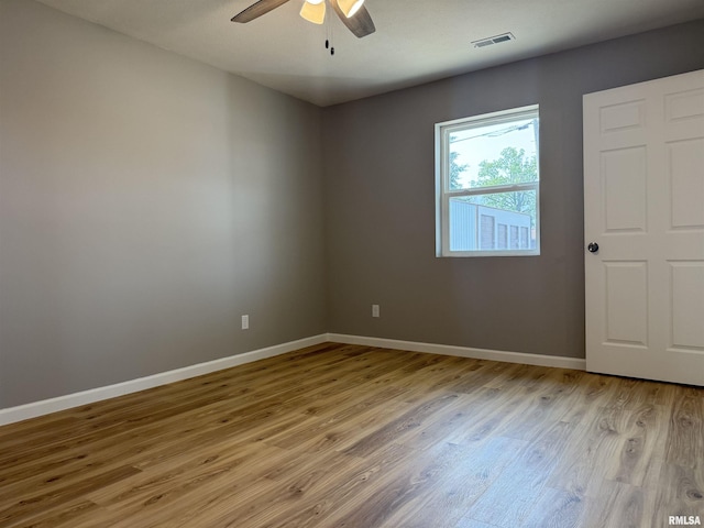 1609 W Chestnut St, Marion, IL 62959 - unfurnished room with light wood-style floors, ceiling fan, and baseboards