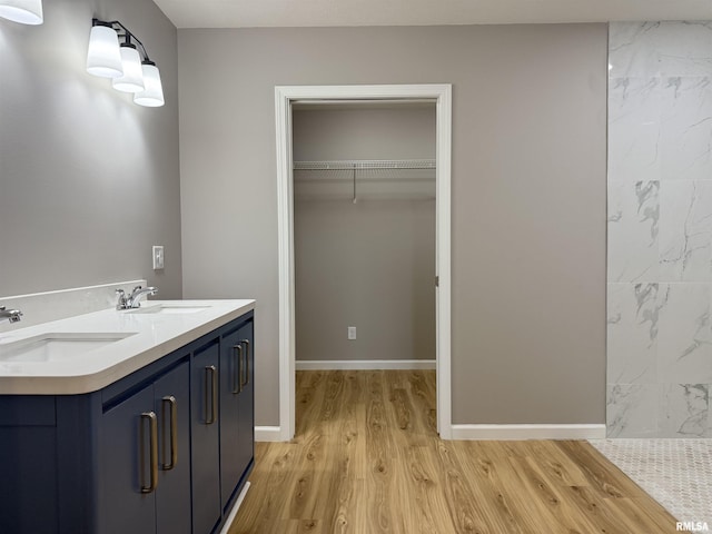 1609 W Chestnut St, Marion, IL 62959 - full bath with wood finished floors, double vanity, a shower, and a walk in closet
