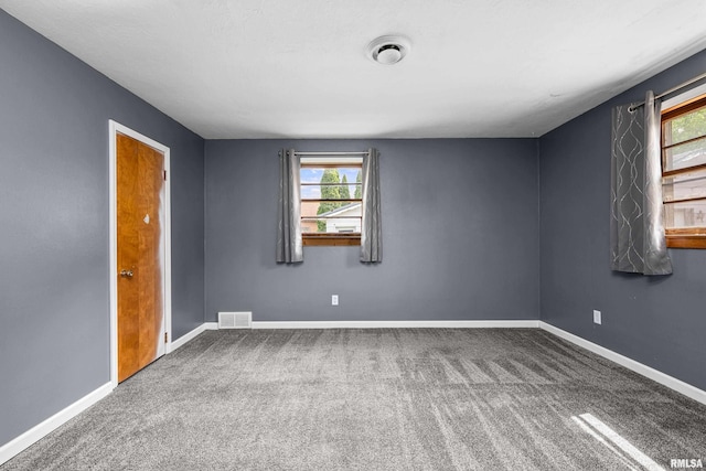 129 State St, Carbon Cliff, IL 61239 - spare room featuring healthy amount of natural light, carpet floors, and baseboards