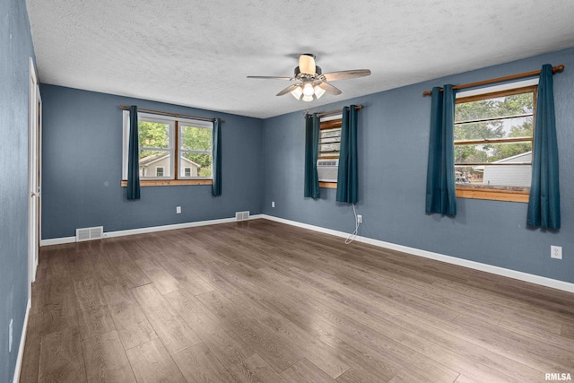 129 State St, Carbon Cliff, IL 61239 - spare room featuring wood finished floors, ceiling fan, a textured ceiling, baseboards, and cooling unit