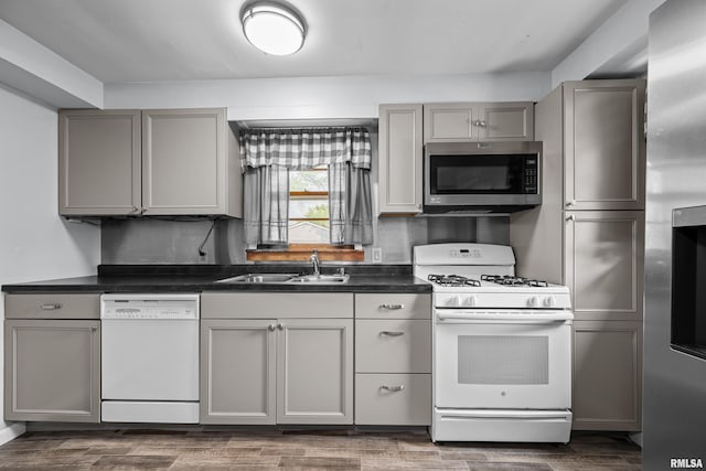 129 State St, Carbon Cliff, IL 61239 - kitchen featuring stainless steel appliances, gray cabinets, a sink, and dark countertops