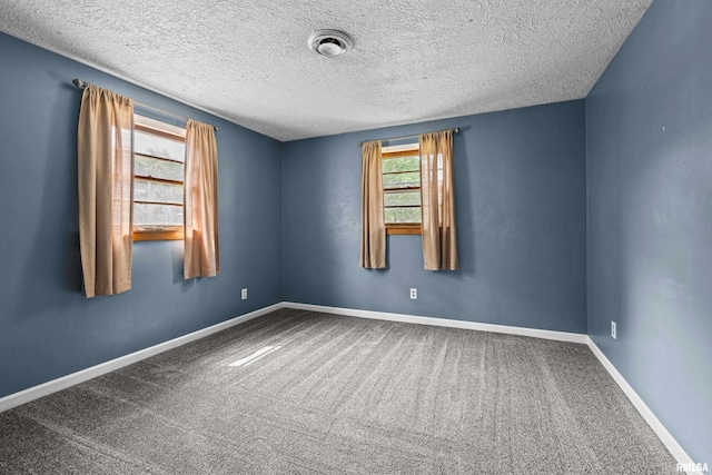 129 State St, Carbon Cliff, IL 61239 - empty room with carpet flooring, baseboards, and a textured ceiling
