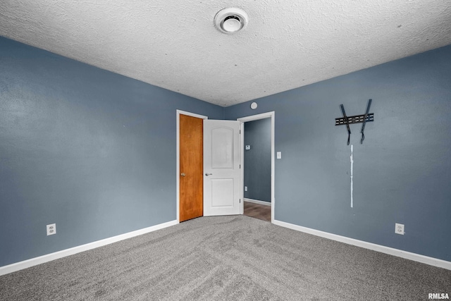 129 State St, Carbon Cliff, IL 61239 - unfurnished bedroom featuring baseboards, carpet, and a textured ceiling