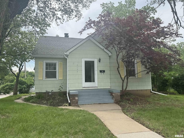 2139 10th St, East Moline, IL 61244 - bungalow with a shingled roof, a front yard, and a chimney