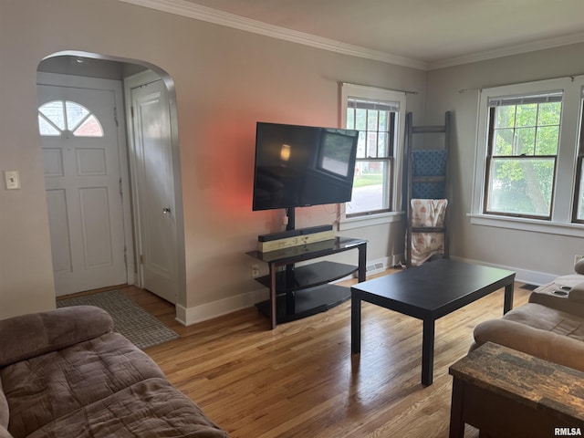 2139 10th St, East Moline, IL 61244 - living room with light wood-style floors, arched walkways, baseboards, and crown molding