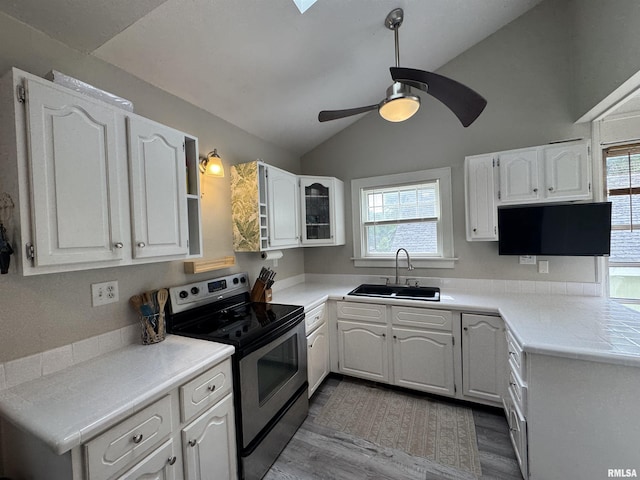 2139 10th St, East Moline, IL 61244 - kitchen with a sink, electric range, lofted ceiling, plenty of natural light, and wood finished floors