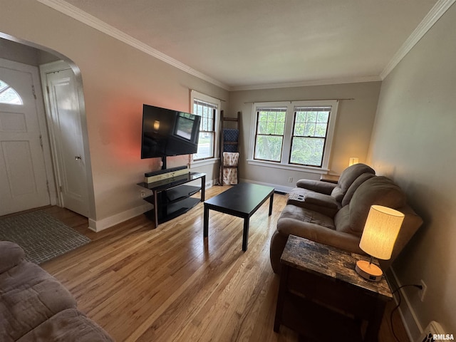 2139 10th St, East Moline, IL 61244 - living room featuring arched walkways, wood finished floors, baseboards, and ornamental molding